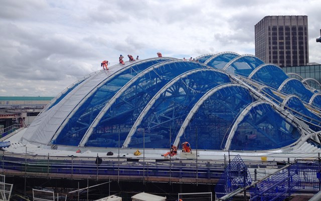 The first material is fitted to the new roof which will cover Birmingham New Street's atrium