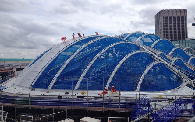 Birmingham New Street milestone reached as atrium roof begins to take shape: The first material is fitted to the new roof which will cover Birmingham New Street's atrium