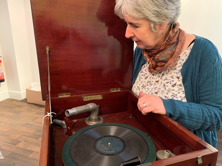 Sounds of Our City: Curator Kitty Ross with a vintage record player which feature sin Sounds of Our City.