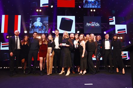 Daisy Hawker Wallace holds PR Week Award surrounded by colleagues from PR agency Mischief