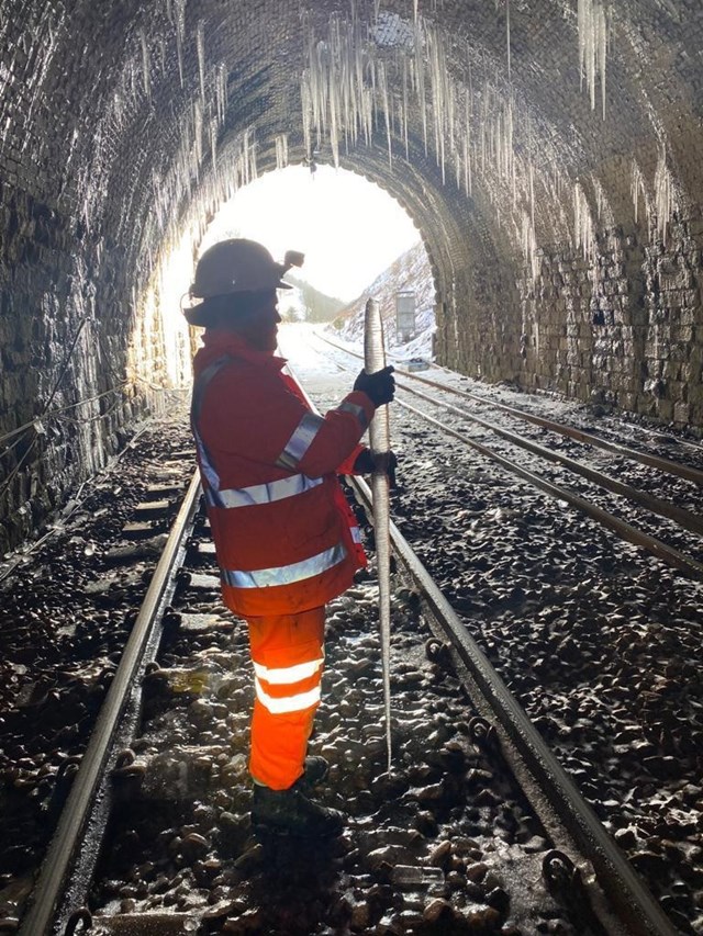 Network Rail worker holding huge icicle