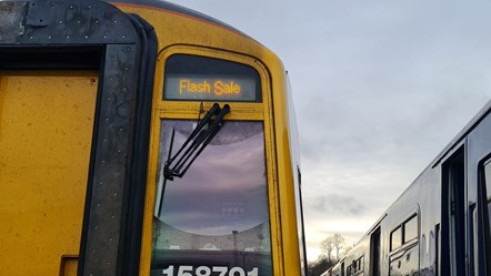 Image shows Flash Sale signage on Northern train
