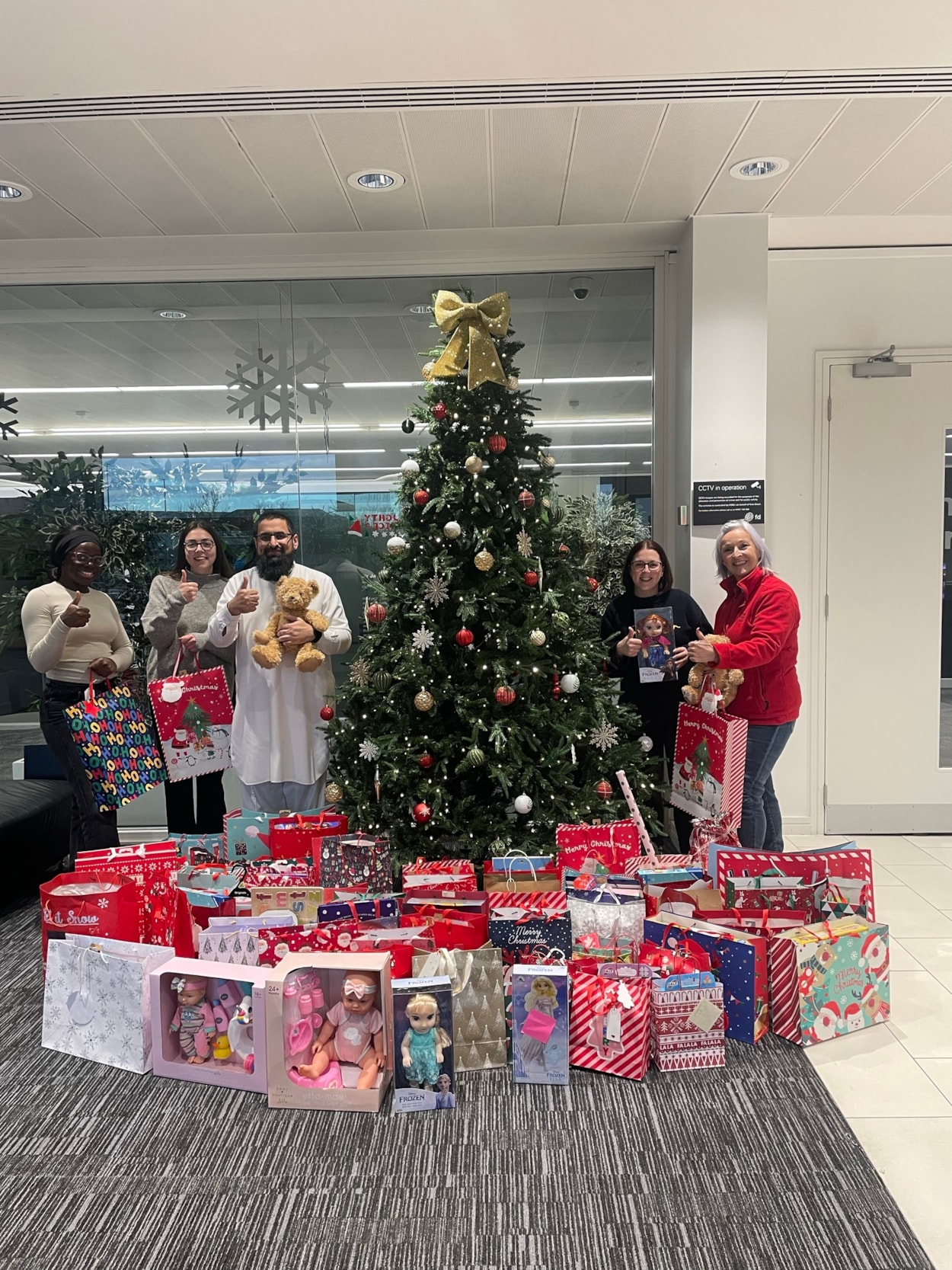 CFL Christmas Gifting 1: Gift exchange at the First Direct offices in Leeds. Pictured: Child Friendly Leeds’ Rowan Beaumont, centre left,  with Eunice Agbemafle and Ahtiram-Ul-Haq Arif of First Direct. Far right, Fran Etherington of Old Fire Station, with Helen Firth, of First Direct.