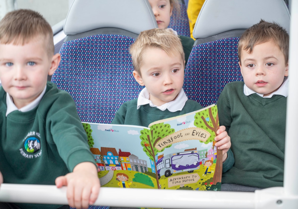 Boys on bus with book