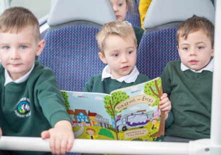 Boys on bus with book