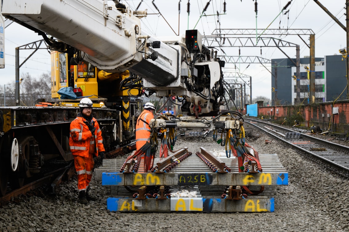 Track panel being lower by a track mounted 'Kirow' crane during Piccadilly upgrades Feb 2026