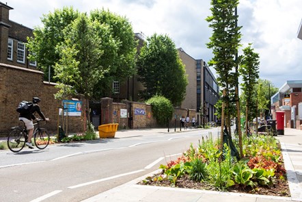 A general view of the Brewery Road entrance to Robert Blair Primary School, showing new flower beds. A resident is cycling past.