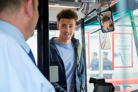 Young customer boarding a First bus