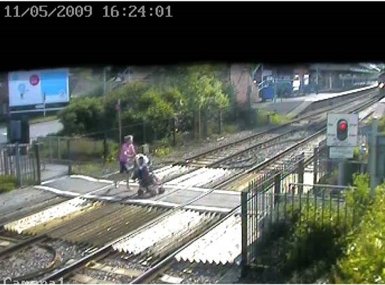 Mother dashes over crossing with baby in pram, Wareham, Dorset