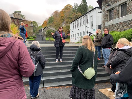 Jo Lusher stands on stone steps at the University of Cumbria Ambleside campus