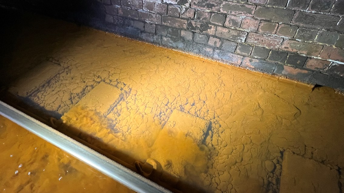 Iron ochre sediment on track ballast inside Whitehaven tunnel November 2023