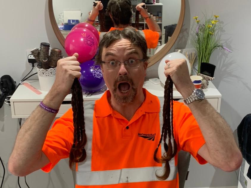 Stuart Hughes with saved locks during haircut copy