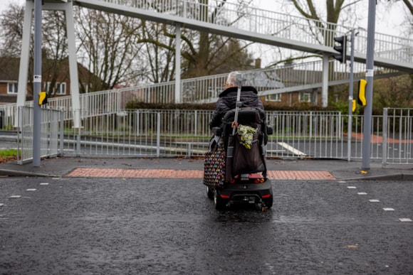 Your voice is needed to shape how Hertfordshire travels tomorrow: Person on mobility scooter crossing the road