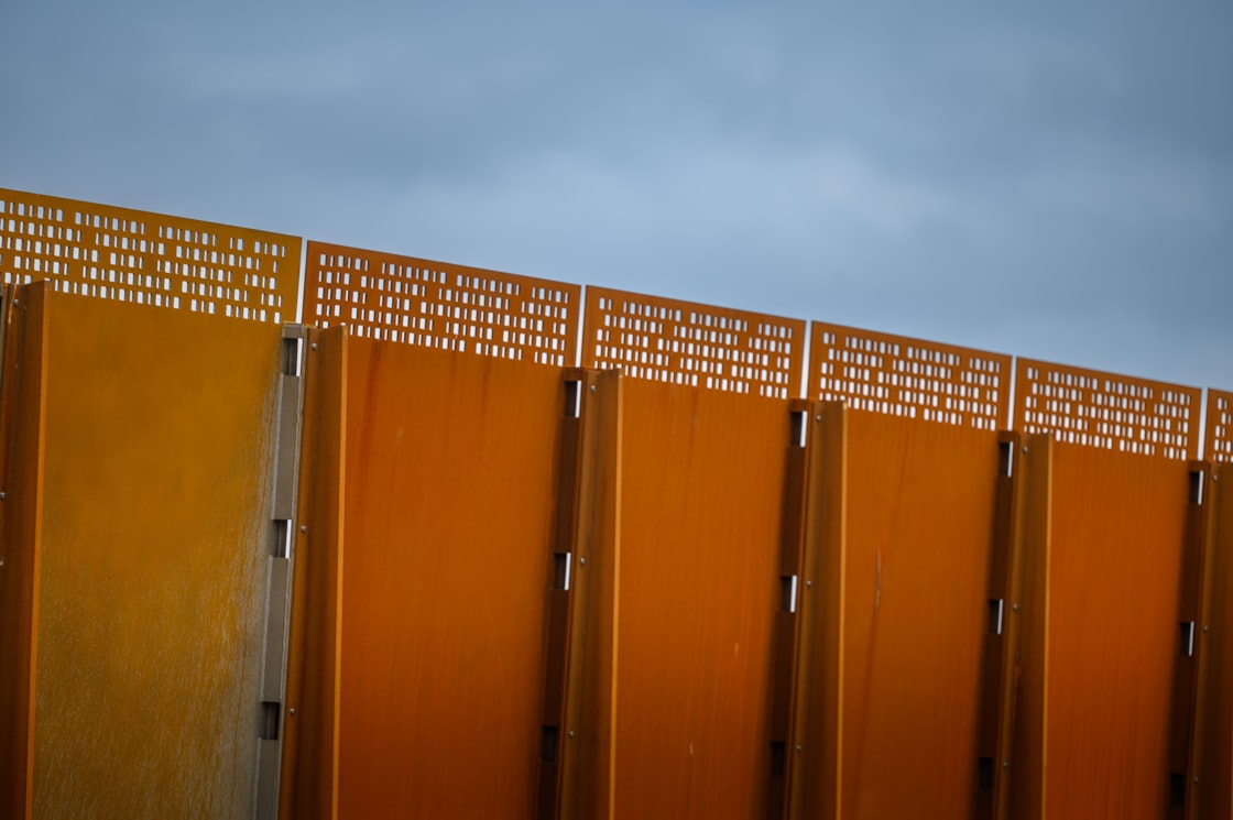 Weathered steel panels incorporate a perforated pattern to maximise light and views