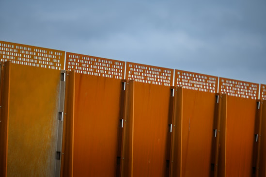 Weathered steel panels incorporate a perforated pattern to maximise light and views