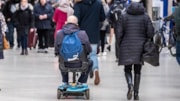 mobility-scooter-user-news-cover: Mobility scooter user (left) on a  railway station platform