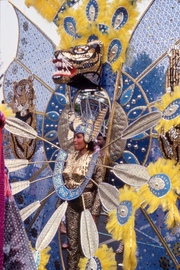 TfL celebrates 70 years of London Transport's Caribbean recruitment campaign and 60 years of Notting Hill Carnival: LTM Image - Woman in a tiger head costume at Notting Hill Carnival, by Hugh Robertson, 1984 © TfL from London Transport Museum's collection