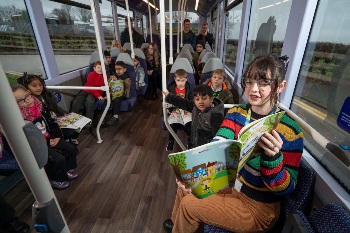 Cllr Maloney reading on bus