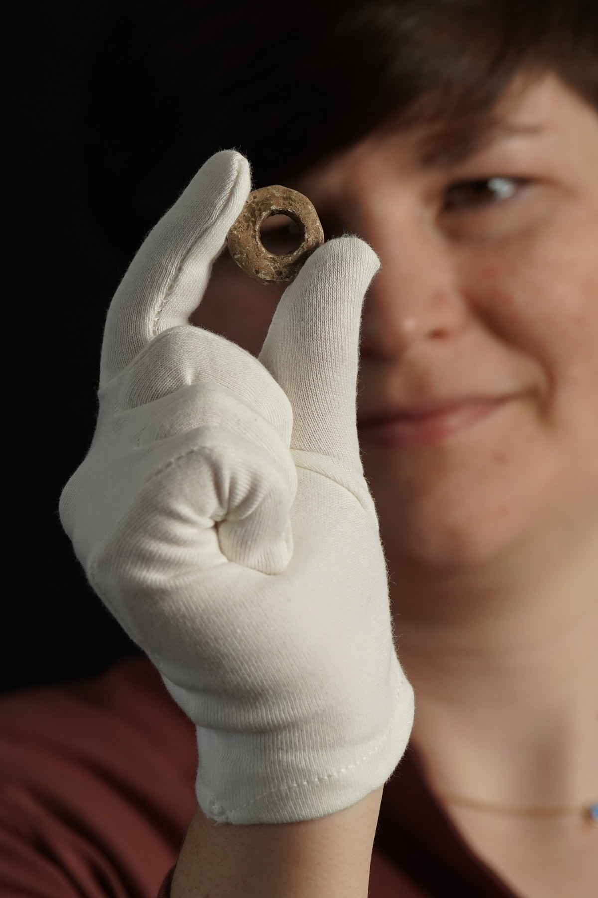 Janel Fontaine, Treasure Trove Officer, with the Medieval spindle whorl. Photo (c) Stewart Attwood. (5)