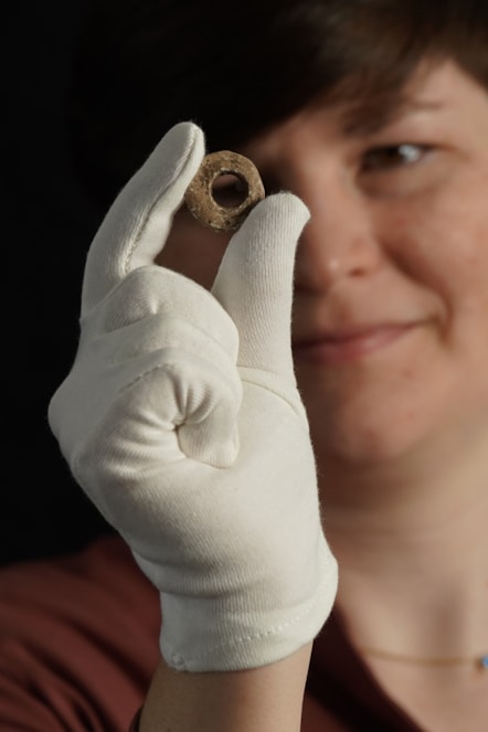 Janel Fontaine, Treasure Trove Officer, with the Medieval spindle whorl. Photo (c) Stewart Attwood. (5)