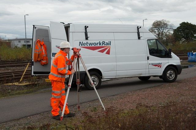 Engineer using equipment from van