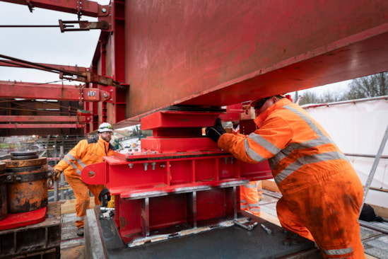 The nose of the Small Dean deck being slid onto temporary bearings on top of a pier Feb 2025