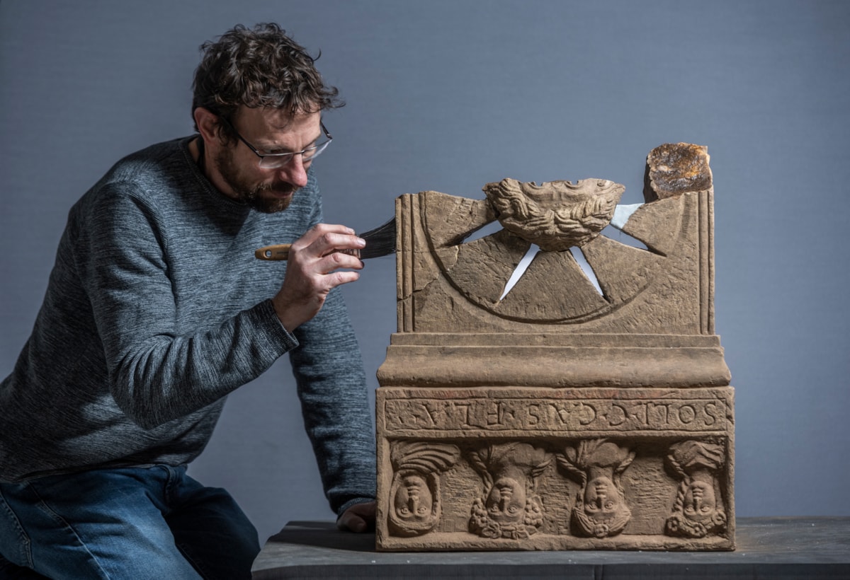 Conservator Charles Stable works on the Roman altar. Photo © Phil Wilkinson