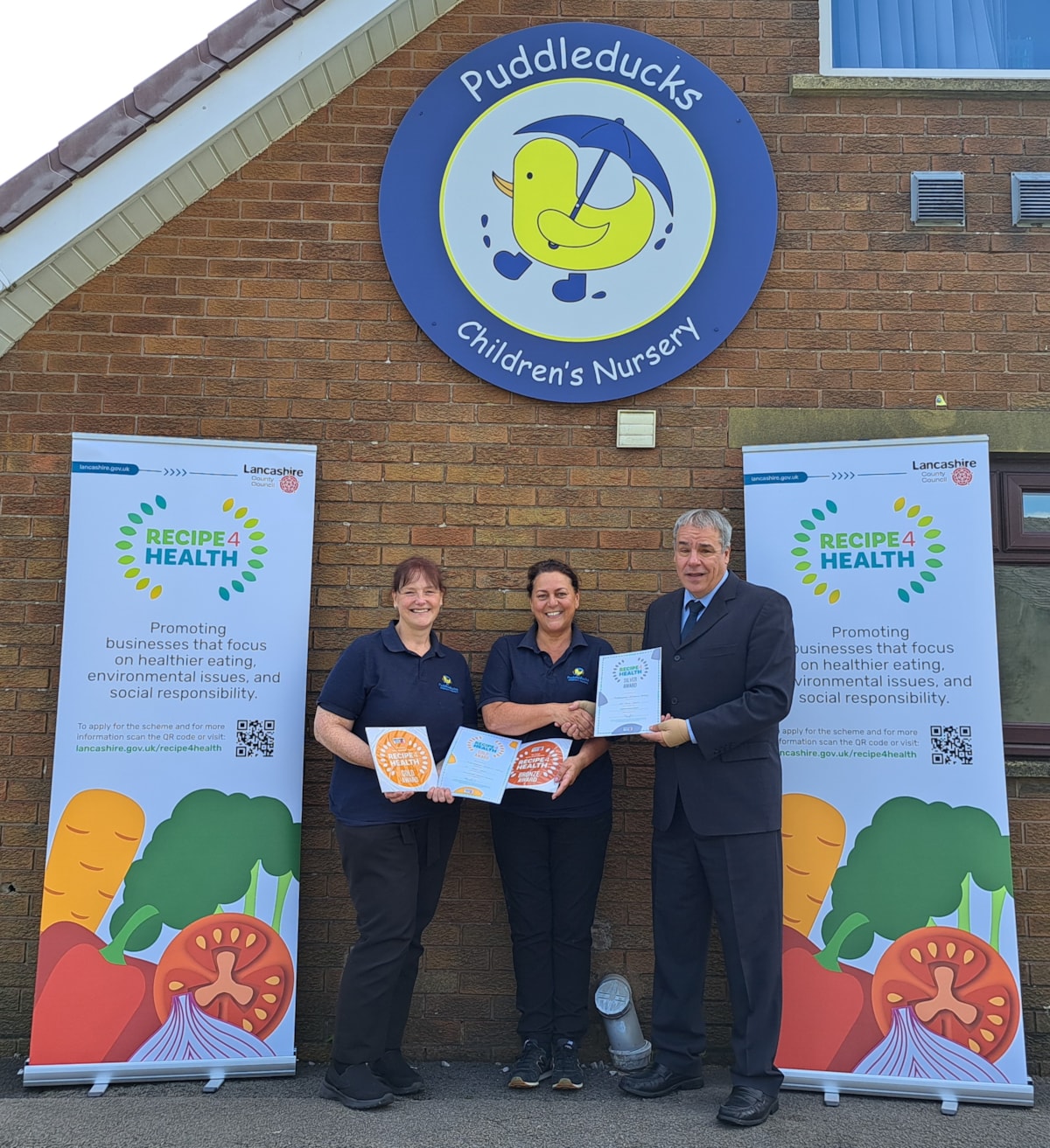 From left: Puddleducks Children's Nursery staff Clare Wilson and Joanne Earnshaw accept the Awards from Jamal Dermott, Recipe 4 Health lead at Lancashire County Council