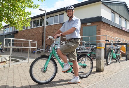 Councillor Robert Savage, County Councillor for Wymondham, sat on a Beryl bike at the launch of the Norwich scheme extension.