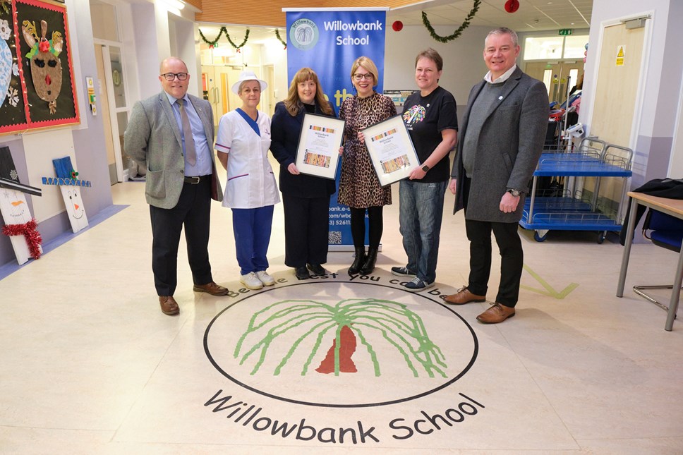 Cllr Cowan presents a certificate to HT Tracy Smallwood, with Mark Hunter from Catering Services, David Doran from Health and Safety plus Janet Black from Willowbank Catering team and Jayne Sangstr, Chair of the Parent Council