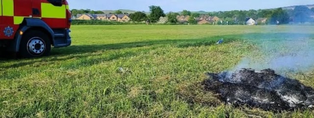 a burnt bbq next to a LFRS fire engine