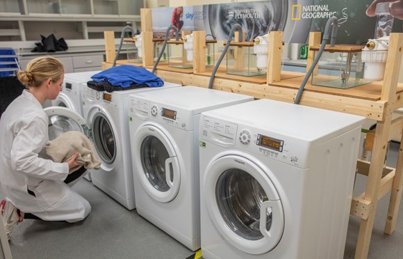 Study shows devices can reduce fibres released in laundry cycle by up to 80%: Dr Imogen Napper loads up a washing machine as part of the study (Credit University of Plymouth)