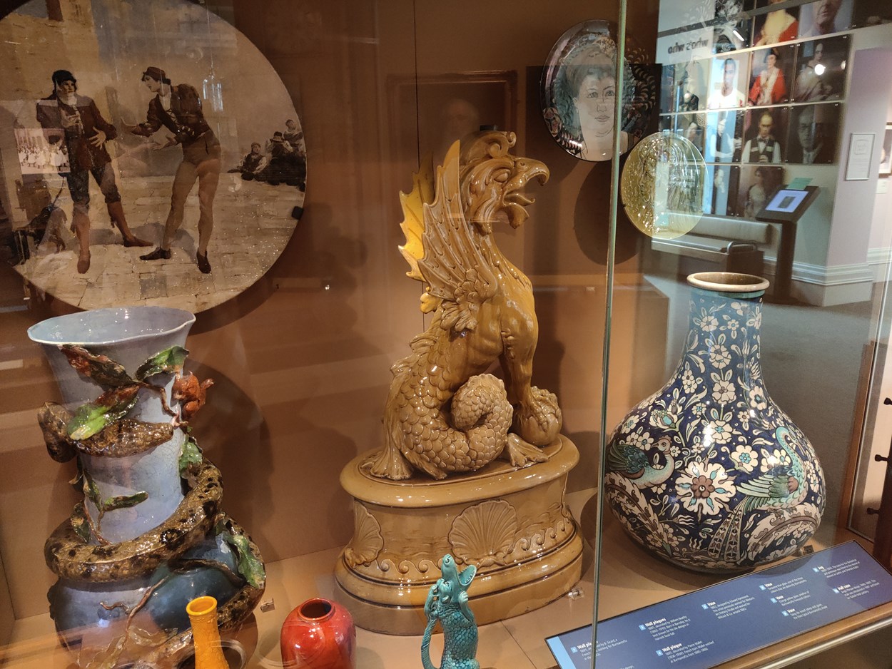 Legends at Leeds City Museum: Large yellow ceramic stand of a seated griffin with serpent tail, Leeds Fireclay Company Ltd,  1880 – 1889.