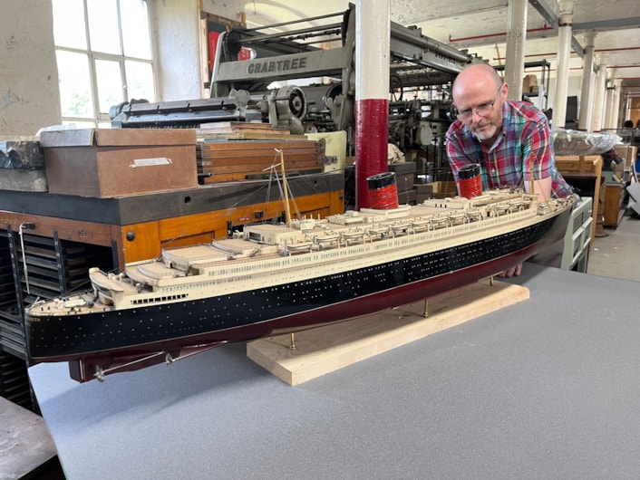 Model ships: Curator John McGoldrick with a scale replica of the famed cruise liner the RMS Queen Elizabeth. More than a metre-and-a-half long, the model is a tribute to the much larger original, which was once the biggest passenger ship ever built at more than a thousand feet in length.
Made in Clydebank, Scotland, and launched in 1938, the full-sized ship was operated by Cunard Line and provided a weekly transatlantic service between Southampton and New York City.