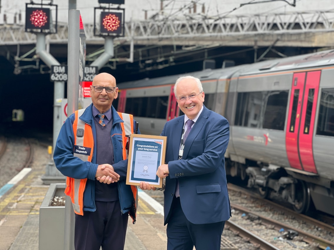 Paul being presented with his long-service award by Fraser Pithie, station operations manager