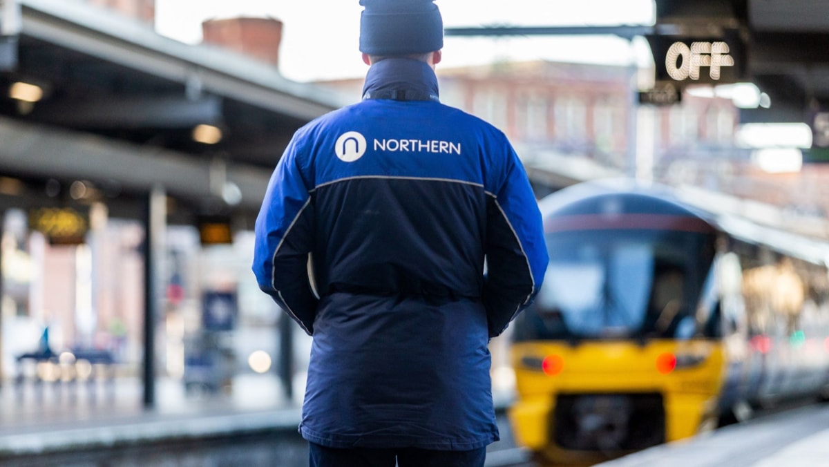 Image shows Northern member of staff on a platform at Leeds station