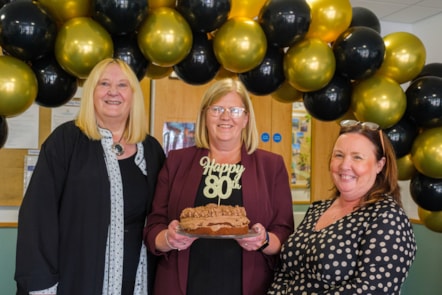 Current Head of Centre Margaret Blades holds a birthday cake along with previous heads Rona Burns and Carol McGregor
