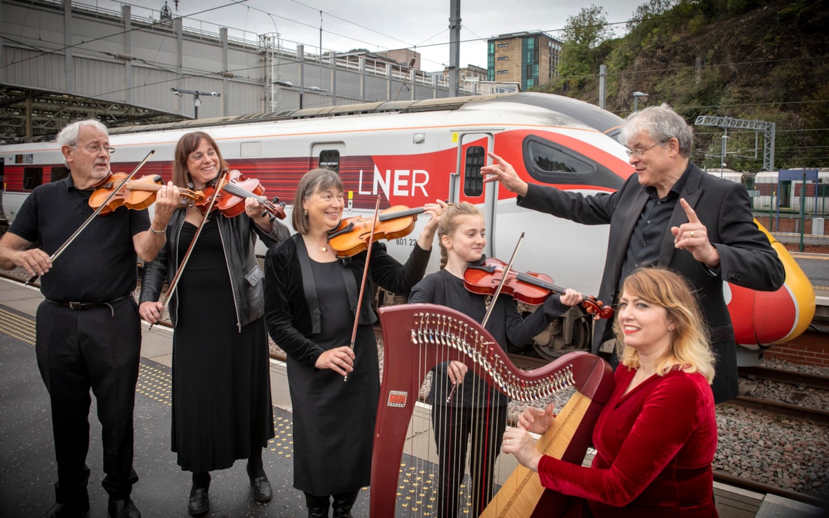 Linlithgow String Orchestra besides an LNER Azuma at Edinburgh Waverley station.