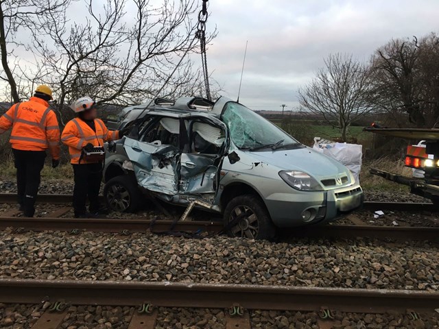 Damaged vehicle being recovered following fatal collision at Marston level crossing