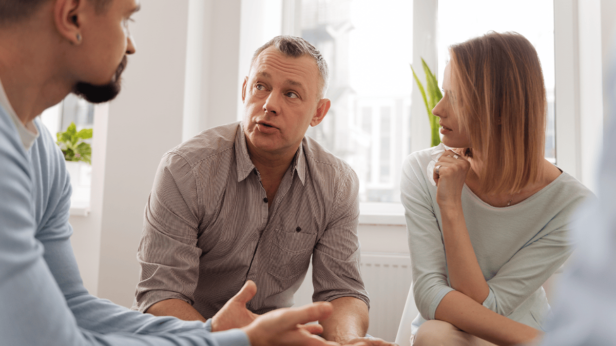 Social workers talking: Three social workers are sitting together, having a discussion.