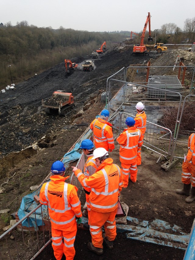 Visitors to the Harbury landslip watch work taking place to remove material from the cutting
