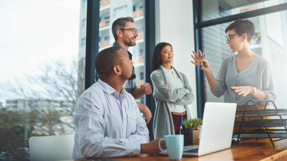 Colleagues standing in meeting