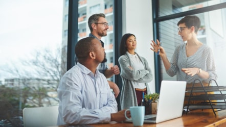 Colleagues standing in meeting