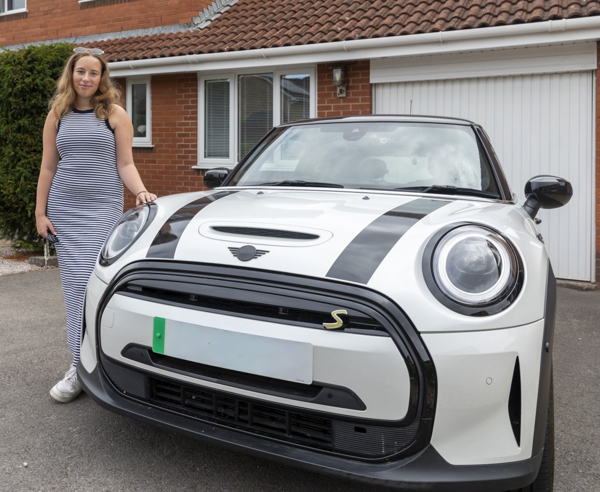E.ON Next customer Abi stands next to her EV.