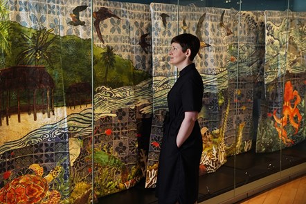 Curator Dr Ali Clark admires a set of five kimono which make up an artwork entitled Song of Samoa, by internationally renowned artist Yuki Kihara, part of a new exhibition, Rising Tide: Art and Environment in Oceania which opens Saturday 12 August at the National Museum of Scotland (credit Stewart A
