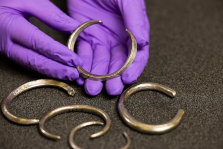 Assistant Curator Craig Angus with silver arm rings from the Burray Hoard. Photo © Duncan McGlynn (2)