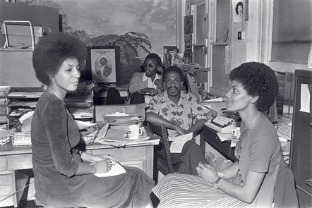 Caption: Tony Douglas (deputy editor) and Russell Pierre (editor) of the
West Indian World, the first national black newspaper in the
UK. They are interviewing journalist Leila Howe Hassan (left),
member of the Black Unity, Freedom Party and editor of Race
Today newspaper. She sits opposite her coll