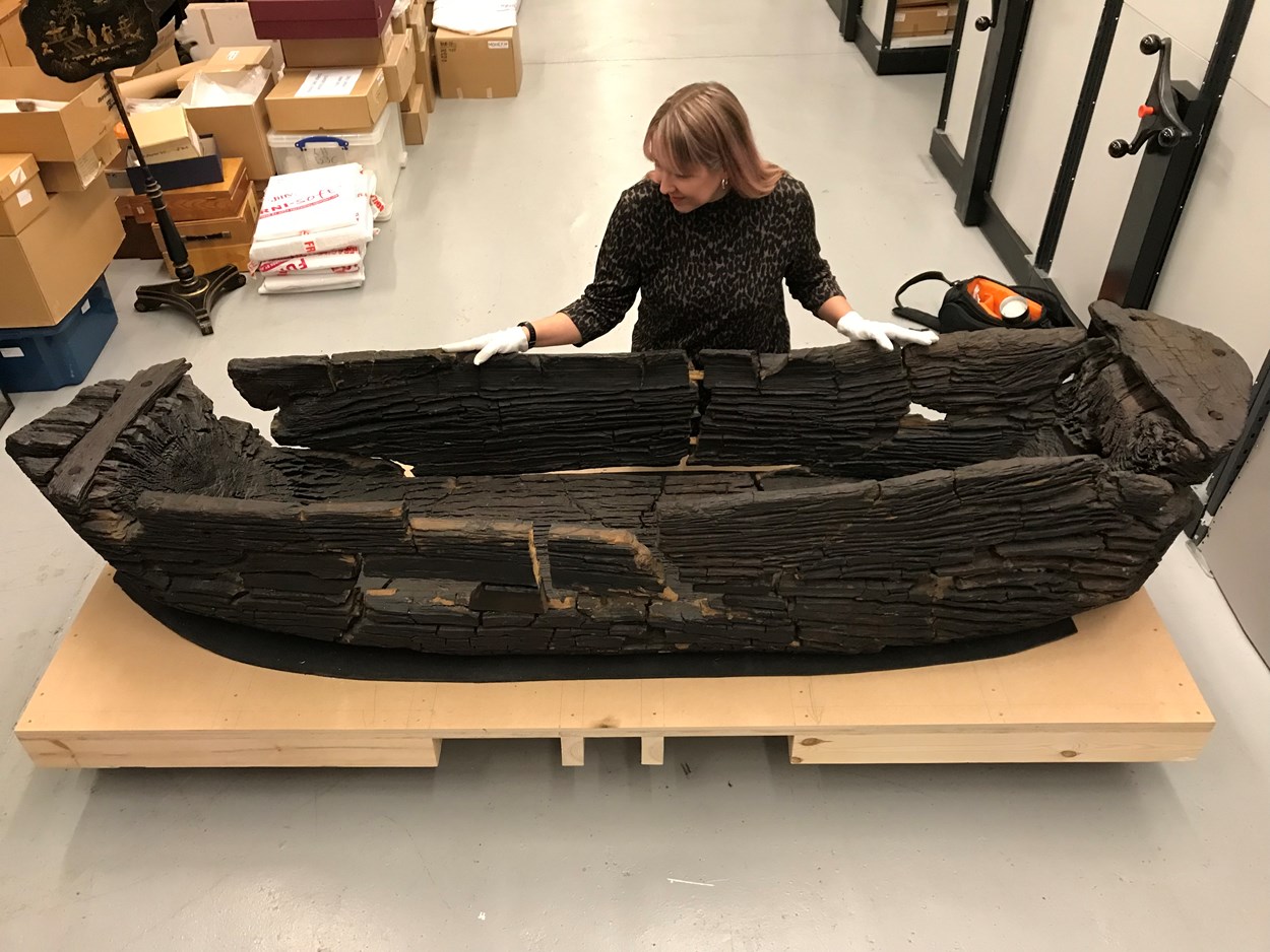 Giggleswick Tarn logboat: Kat Baxter, Leeds Museums and Galleries curator of archaeology with the centuries-old carved logboat, which dates from the 1300s. The  watercraft had lain beneath the soil for more than 500 years before being discovered by Joseph Taylor in 1863 while he was digging some drainage works near Giggleswick Tarn in North Yorkshire.