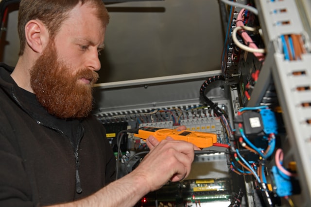 Electrical Power Generation Technician carries out checks. BAS.