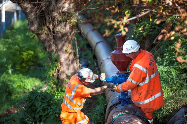 Engineers install a new pipe which will carry rain water away